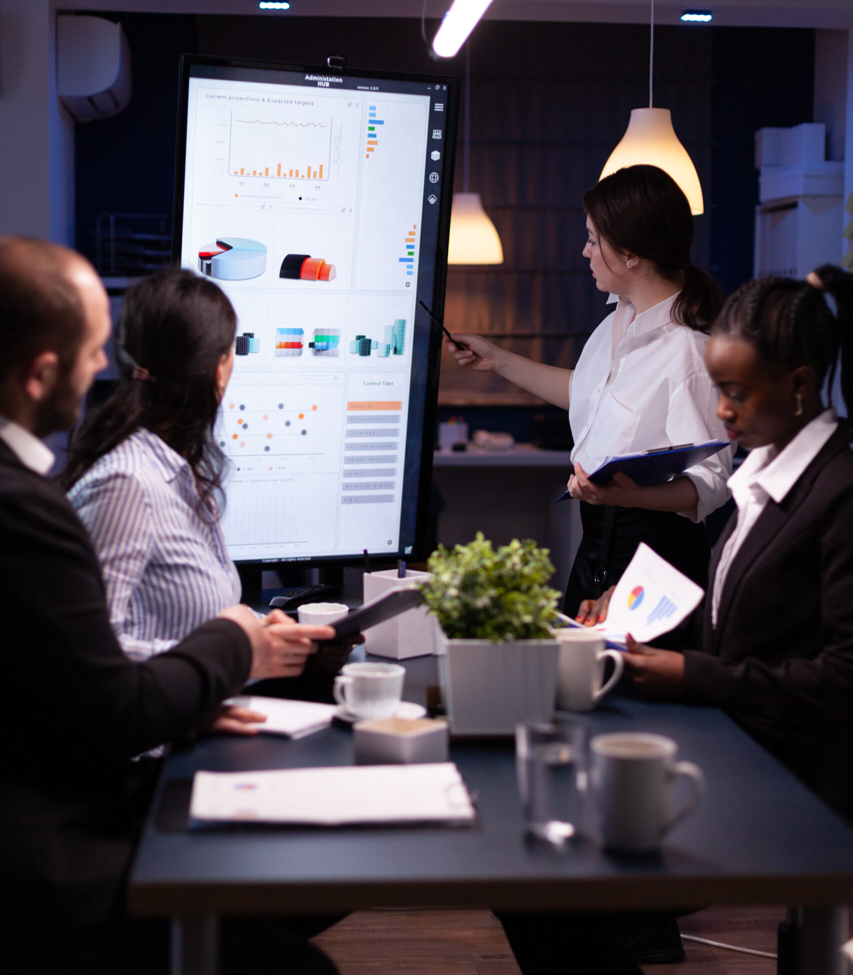 diverse-multi-ethnic-business-teamwork-overworking-office-meeting-room-analyzing-financial-graphs-scaled (1)